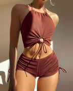 Model wearing the PeechLove Halter Bikini Shorts Set at the poolside, highlighting its stylish look and coverage.