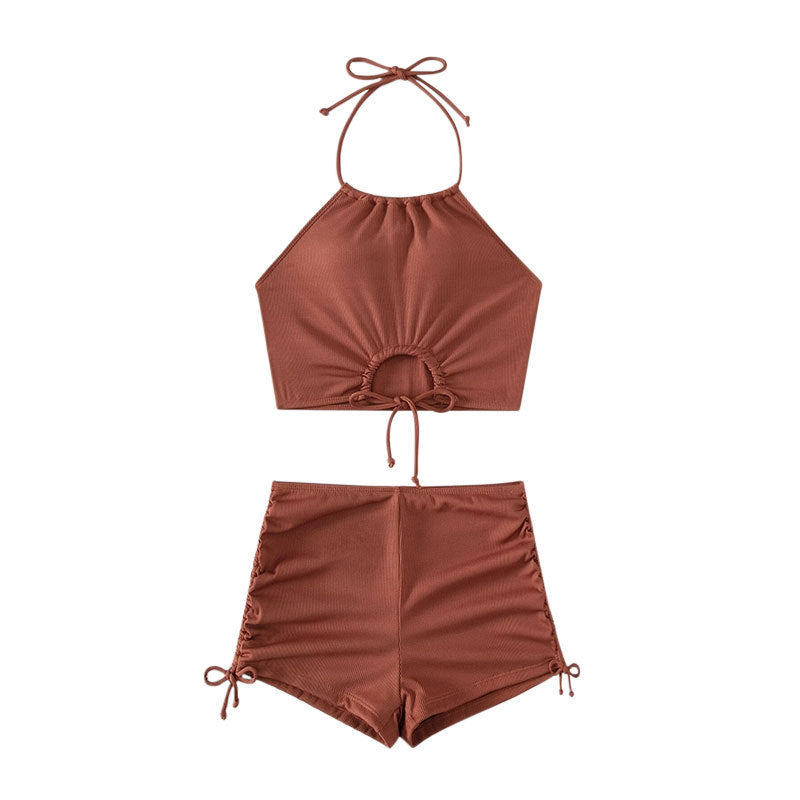 Detail shot of the side-tie features of the high waisted swim shorts from the Halter Bikini Shorts Set.