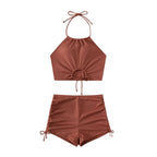 Detail shot of the side-tie features of the high waisted swim shorts from the Halter Bikini Shorts Set.