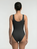 Back view of black bust support bodysuit with seamless shaping and smooth coverage