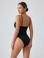 Back angled view of black plunge thong bodysuit with smooth open-back support