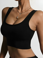 Close-up of black push-up sports bra with scoop neckline and smooth lift support