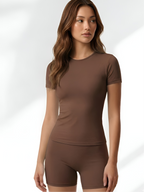 Brown short sleeve yoga set for women with fitted top and matching biker shorts