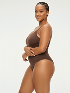 Angled front view of brown soft shaping bodysuit with seamless shaping support