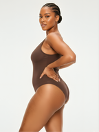 Side view of brown soft shaping bodysuit with body-contouring and smoothing fit