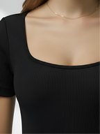 Close-up of black square neck bodysuit with ribbed stretch fabric and smooth neckline