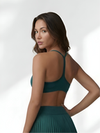Back view of dark green women’s sports bra with supportive straps for workout comfort