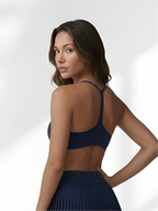 Back view of navy blue women’s sports bra with supportive straps and smooth fit