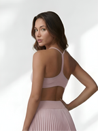 Back view of pink women’s sports bra with strappy support and smooth activewear fit