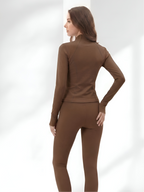 Back view of brown yoga wear set with stretch leggings and fitted jacket