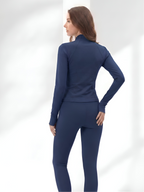 Back view of navy blue yoga wear set with sculpting leggings and zip jacket