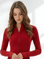 Close-up of red yoga wear set with fitted long sleeve workout jacket