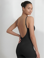 Angled back view of black backless shorts bodysuit with open back and smooth fit
