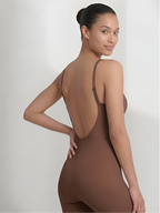 Angled back view of brown backless bodysuit with shorts and low open back