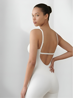Angled back view of white backless shorts bodysuit for open-back dresses