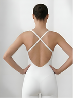 Back view of white backless shorts bodysuit with crisscross straps and open back design